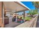 Relaxing covered patio with outdoor seating and a view of the well-maintained backyard at 819 Arrowhead Trl, Henderson, NV 89002