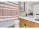 Well-lit bathroom featuring vanity, toilet, and patterned shower curtain at 8255 One Las Vegas Blvd # 504, Las Vegas, NV 89123