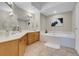 Luxurious bathroom featuring double sinks, granite countertops, and a relaxing soaking tub at 8255 One Las Vegas Blvd # 504, Las Vegas, NV 89123