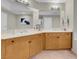 Bathroom with double sinks, large mirrors, and wood cabinets at 8255 One Las Vegas Blvd # 504, Las Vegas, NV 89123