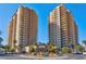 Exterior view of high-rise condo buildings with palm trees and blue sky at 8255 One Las Vegas Blvd # 504, Las Vegas, NV 89123