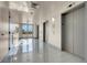 Brightly lit hallway featuring gray tiled floors and elevators with exterior view access at 8255 One Las Vegas Blvd # 504, Las Vegas, NV 89123