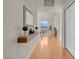 Hallway view of dining area, modern light fixture, and wood floors at 8255 One Las Vegas Blvd # 504, Las Vegas, NV 89123