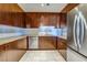 Galley kitchen featuring stainless steel appliances and stone countertops at 8255 One Las Vegas Blvd # 504, Las Vegas, NV 89123