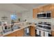 Modern kitchen with granite counters, stainless appliances, and open view of living and dining areas at 8255 One Las Vegas Blvd # 504, Las Vegas, NV 89123