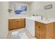 Bright laundry room with modern appliances, storage cabinets, and a utility sink at 8255 One Las Vegas Blvd # 504, Las Vegas, NV 89123