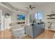 Bright living room features wood floors, a ceiling fan, large windows, and a comfortable leather sofa at 8255 One Las Vegas Blvd # 504, Las Vegas, NV 89123