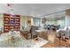 Stylish lounge area with a large bookcase, comfortable seating, and a glass-walled room at 8255 One Las Vegas Blvd # 504, Las Vegas, NV 89123
