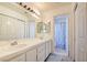 Bathroom has dual sinks with vanity, drawers and an adjacent shower at 8370 Lost Lake Ct, Las Vegas, NV 89147