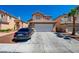 Attractive two-story home with a tile roof, attached garage, and a concrete driveway in a suburban neighborhood at 8370 Lost Lake Ct, Las Vegas, NV 89147