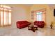 Cozy living room with tile floors, natural light and comfortable seating at 8370 Lost Lake Ct, Las Vegas, NV 89147