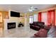 Comfortable living room with fireplace, tile floor, and access to outdoor patio at 8370 Lost Lake Ct, Las Vegas, NV 89147