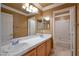 Bright bathroom featuring a double sink vanity, large mirror, and a separate toilet and shower area at 9923 Sierra Canyon Way, Las Vegas, NV 89147