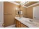 Bright bathroom featuring a double sink vanity, a large mirror, and a separate toilet and shower area at 9923 Sierra Canyon Way, Las Vegas, NV 89147