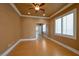 Bedroom with wood floors, ceiling fan, and mirrored closet, enhancing storage and style at 9923 Sierra Canyon Way, Las Vegas, NV 89147