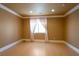 Neutral bedroom featuring wood floors, crown moulding, and natural light for peaceful retreat at 9923 Sierra Canyon Way, Las Vegas, NV 89147