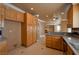 Well-appointed kitchen with wooden cabinets and breakfast bar, blending seamlessly into the living space at 9923 Sierra Canyon Way, Las Vegas, NV 89147