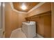 Laundry room with washer and dryer, and overhead storage shelving at 9923 Sierra Canyon Way, Las Vegas, NV 89147