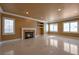 Bright living room features a fireplace and large windows for natural light and shining tile floor at 9923 Sierra Canyon Way, Las Vegas, NV 89147