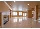 Living room boasts a fireplace, built-in shelving, and tile floors, perfect for entertaining at 9923 Sierra Canyon Way, Las Vegas, NV 89147
