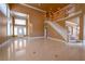 Open floor plan with staircase and tile flooring, flowing natural light through many windows at 9923 Sierra Canyon Way, Las Vegas, NV 89147