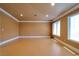 Bright living room featuring recessed lighting, light-colored walls, and a window with decorative curtains at 9923 Sierra Canyon Way, Las Vegas, NV 89147