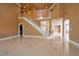 Bright living room with tile flooring, a staircase, and views into other living spaces at 9923 Sierra Canyon Way, Las Vegas, NV 89147