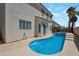 Private backyard featuring a custom pool with steps and a unique curved design at 9923 Sierra Canyon Way, Las Vegas, NV 89147