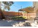 Outdoor backyard space with pergola, fire pit, landscaping, and block wall at 100 Walker Way, Boulder City, NV 89005