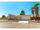 Charming home with desert landscape, palm trees, and a long driveway at 100 Walker Way, Boulder City, NV 89005
