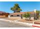 Charming single-story home features a red tile roof and well-manicured landscaping at 100 Walker Way, Boulder City, NV 89005