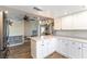 Bright kitchen with white cabinetry, spacious island, and stainless steel appliances at 100 Walker Way, Boulder City, NV 89005