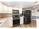 Modern kitchen featuring white cabinets, stone countertops, and stainless steel appliances at 100 Walker Way, Boulder City, NV 89005