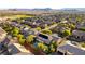 Wide aerial shot of a neighborhood with tan houses and desert mountains in the distance at 10002 Trapper Mountain St, Las Vegas, NV 89178