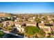 Sweeping aerial view of a property in a lovely neighborhood with nearby mountain views at 10002 Trapper Mountain St, Las Vegas, NV 89178