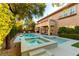 Enjoy outdoor living with a pool, spa, and covered patio in this beautifully landscaped backyard at 10002 Trapper Mountain St, Las Vegas, NV 89178