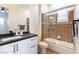 Bathroom featuring a tub and shower combination with brown tiling, complete with black fixtures and neutral finishes at 10002 Trapper Mountain St, Las Vegas, NV 89178