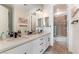 Bathroom with double sink vanity, tile flooring, modern fixtures, and shower over tub combination at 10002 Trapper Mountain St, Las Vegas, NV 89178