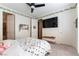 Stylized bedroom featuring light-colored walls, ceiling fan, a comfortable bed, and carpet flooring at 10002 Trapper Mountain St, Las Vegas, NV 89178