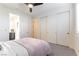 Bedroom with large closet, carpet flooring, a comfortable bed and neutral colored walls at 10002 Trapper Mountain St, Las Vegas, NV 89178