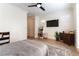 Sunlit bedroom with ceiling fan, a cozy bed, and a modern entertainment setup at 10002 Trapper Mountain St, Las Vegas, NV 89178