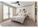 Stylized bedroom with light-colored walls, ceiling fan, a comfortable bed, and light-filtering shutters on French doors at 10002 Trapper Mountain St, Las Vegas, NV 89178