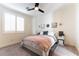 Bedroom featuring light-colored walls, stylish ceiling fan, a comfortable bed and light-filtering shutters at 10002 Trapper Mountain St, Las Vegas, NV 89178