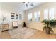 Versatile bonus room offering natural light from large windows, complemented by neutral décor and a cozy area rug at 10002 Trapper Mountain St, Las Vegas, NV 89178