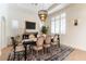 Elegant dining room features a modern chandelier, plantation shutters, and stylish decor at 10002 Trapper Mountain St, Las Vegas, NV 89178