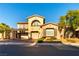 Charming home featuring an arched balcony, three-car garage, and desert landscaping at 10002 Trapper Mountain St, Las Vegas, NV 89178