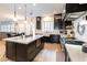 Open concept kitchen features a large island, stainless appliances, and modern lighting at 10002 Trapper Mountain St, Las Vegas, NV 89178
