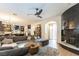 Open-concept living room with fireplace, spacious sofa, and modern decor at 10002 Trapper Mountain St, Las Vegas, NV 89178