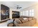Cozy living room with fireplace, large sectional sofa, and custom lighting at 10002 Trapper Mountain St, Las Vegas, NV 89178