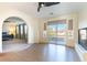 Inviting living room offering ample natural light from large windows, leading to a bedroom for seamless living and relaxing at 10002 Trapper Mountain St, Las Vegas, NV 89178